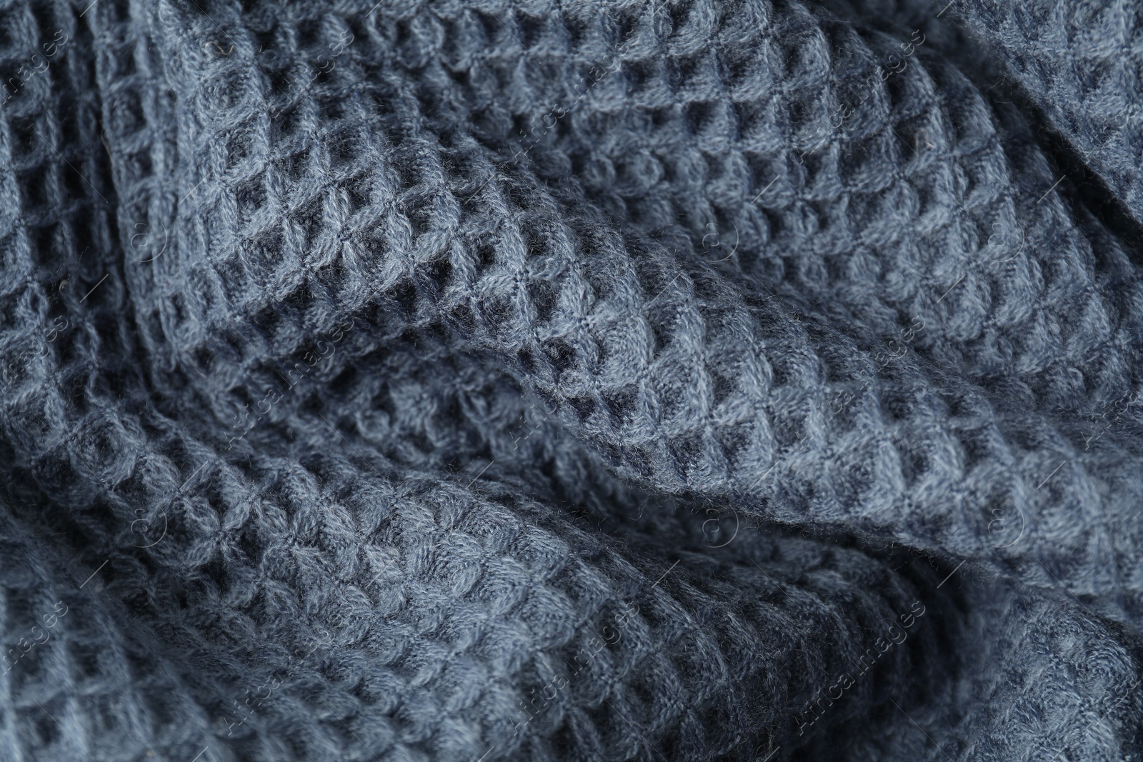 Photo of Texture of blue knitted fabric as background, top view