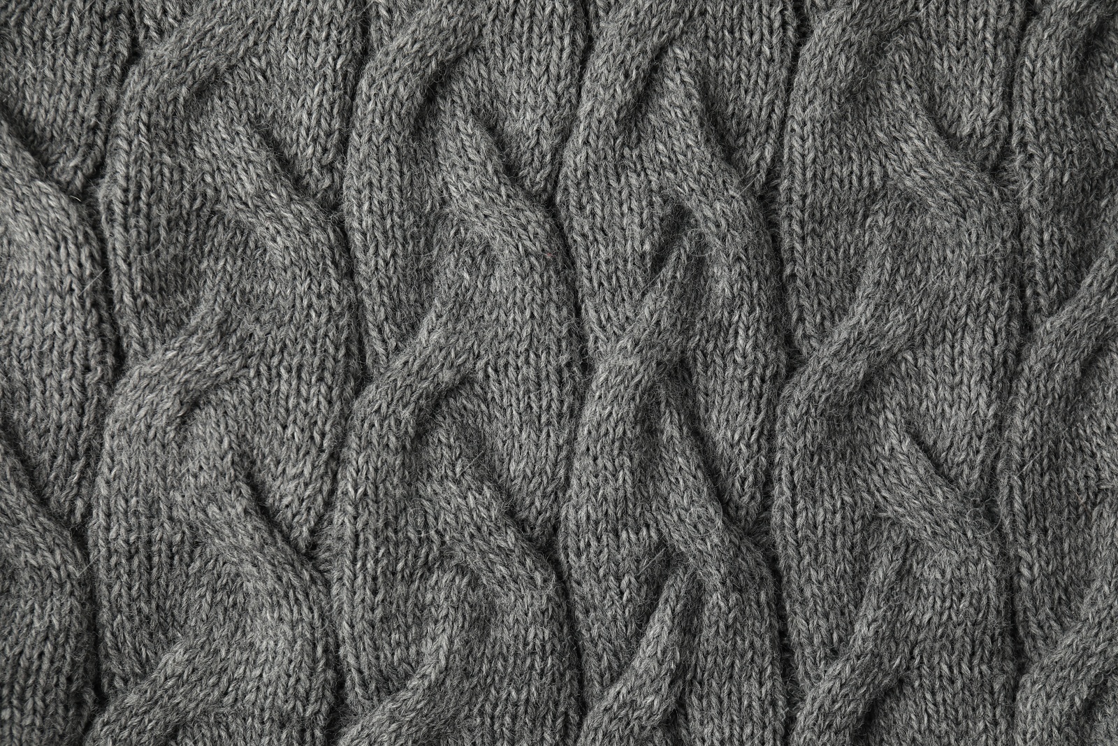 Photo of Texture of grey knitted fabric as background, top view