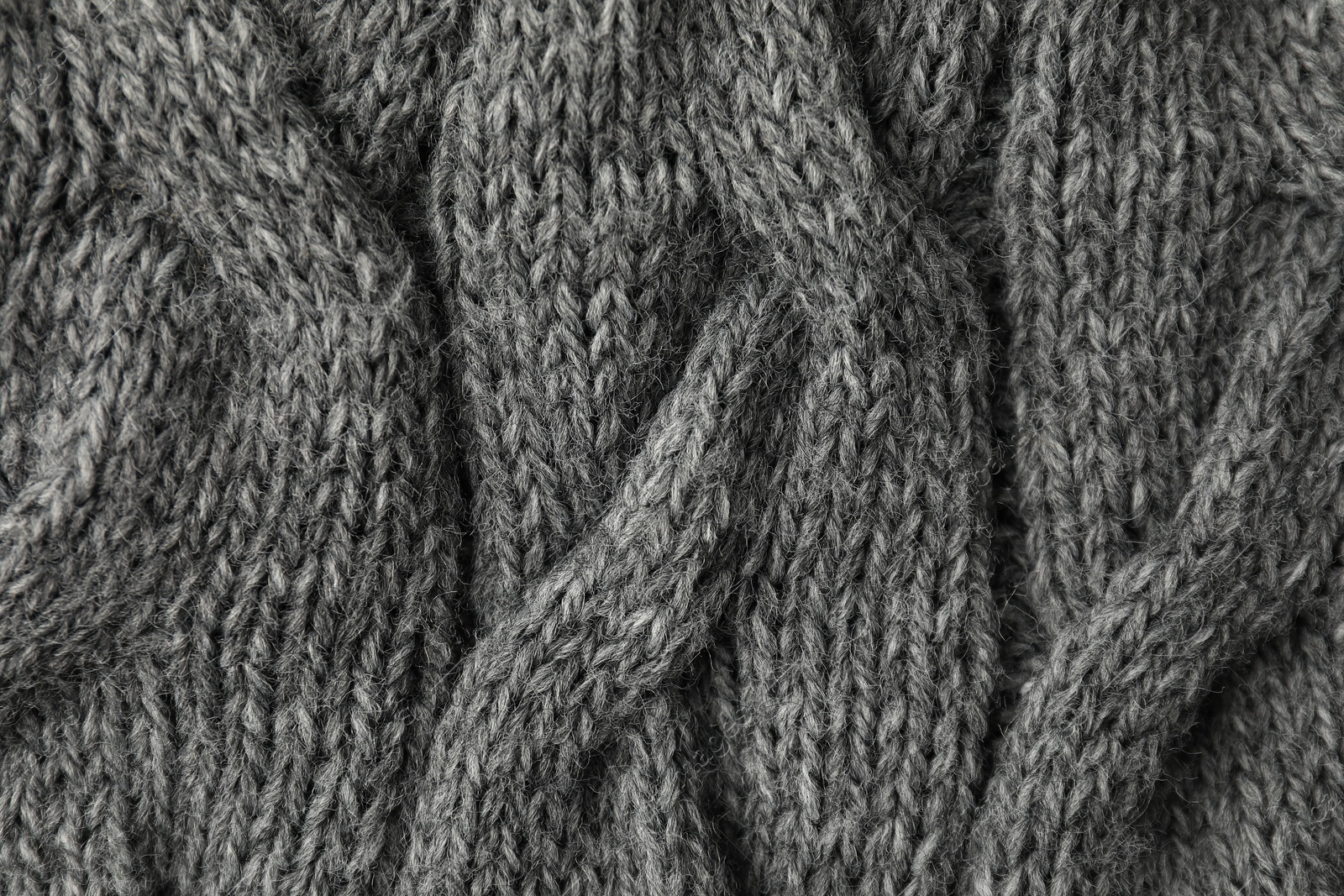 Photo of Texture of grey knitted fabric as background, top view