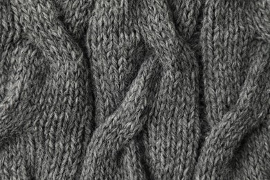 Photo of Texture of grey knitted fabric as background, top view