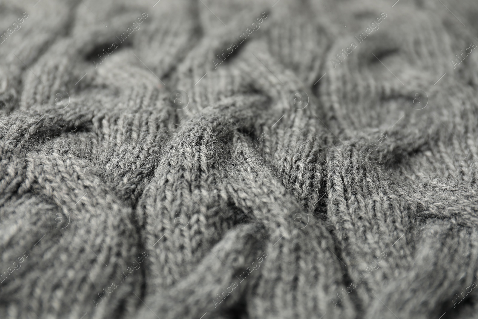 Photo of Texture of grey knitted fabric as background, closeup