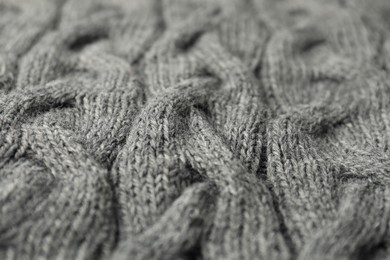 Texture of grey knitted fabric as background, closeup