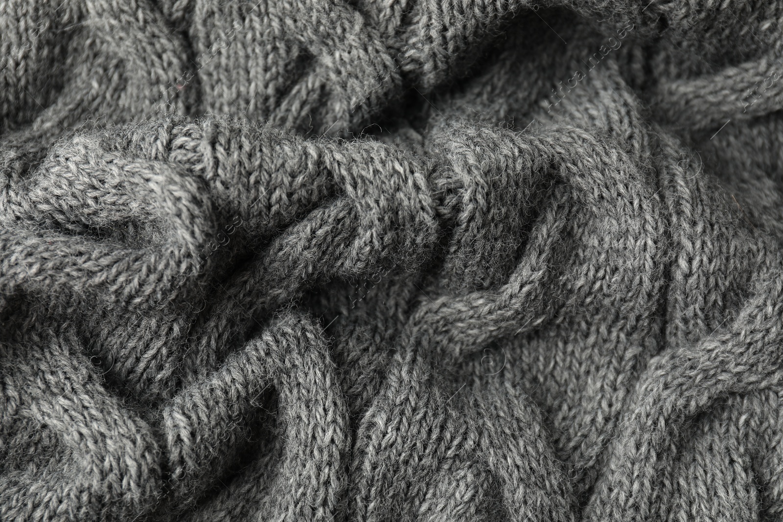 Photo of Texture of grey knitted fabric as background, closeup