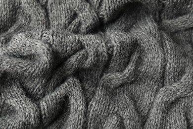 Texture of grey knitted fabric as background, closeup