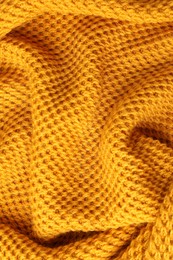 Photo of Texture of orange knitted fabric as background, top view