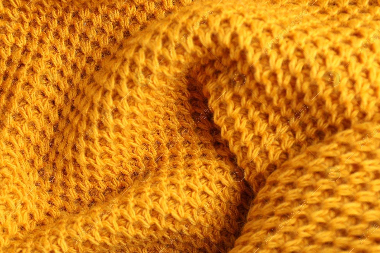 Photo of Texture of orange knitted fabric as background, closeup