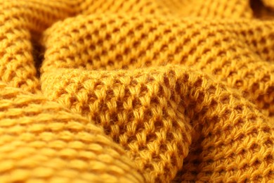 Texture of orange knitted fabric as background, closeup