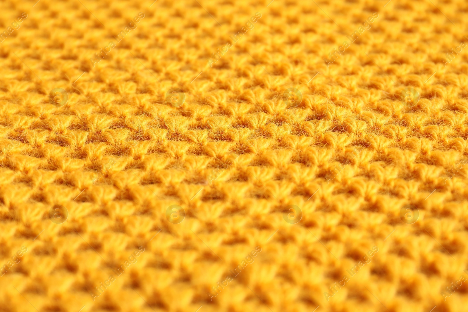 Photo of Texture of orange knitted fabric as background, closeup