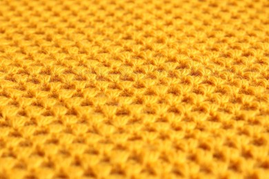 Photo of Texture of orange knitted fabric as background, closeup