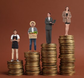 People of various professions on stacks of coins of different height against brown background