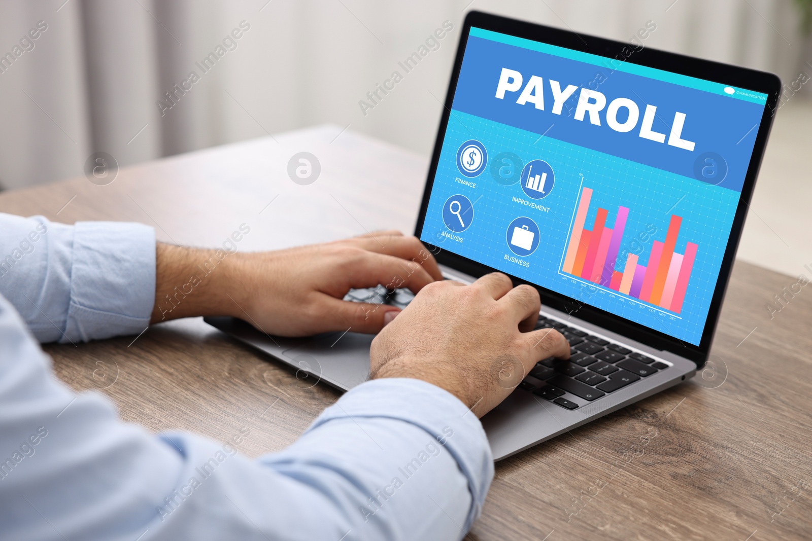 Image of Payroll data. Man working on laptop at table, closeup