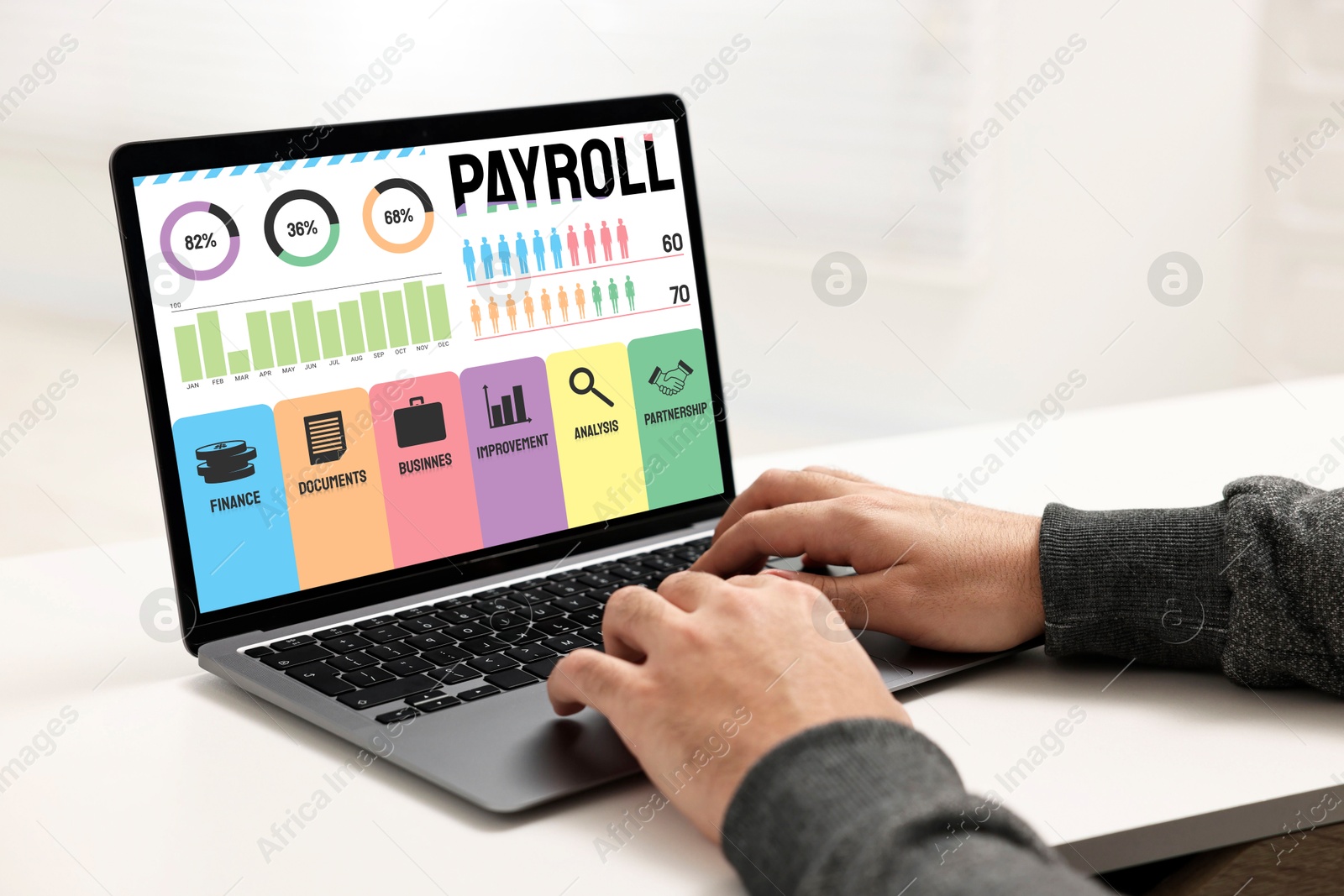 Image of Payroll data. Man working on laptop at table, closeup