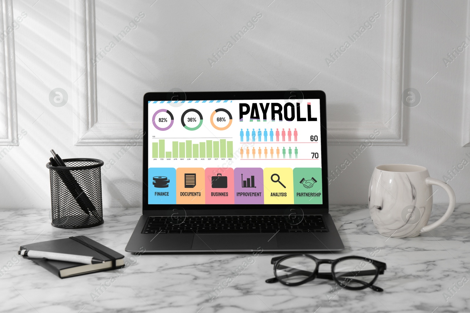 Image of Laptop with payroll data on screen on table