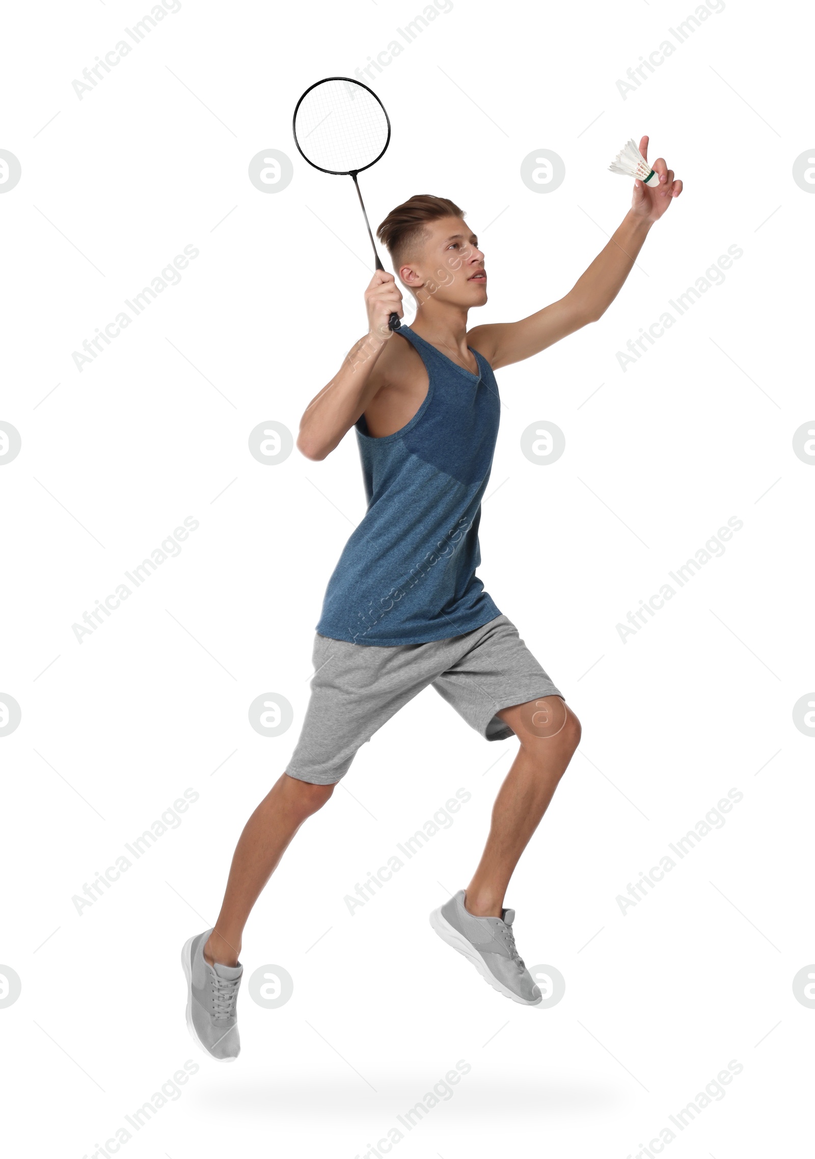 Image of Young man playing badminton with racket and feather shuttlecock on white background