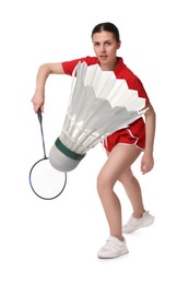 Young woman playing badminton with racket and feather shuttlecock on white background