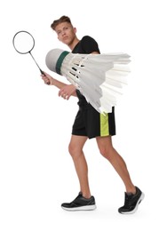 Image of Young man playing badminton with racket and feather shuttlecock on white background