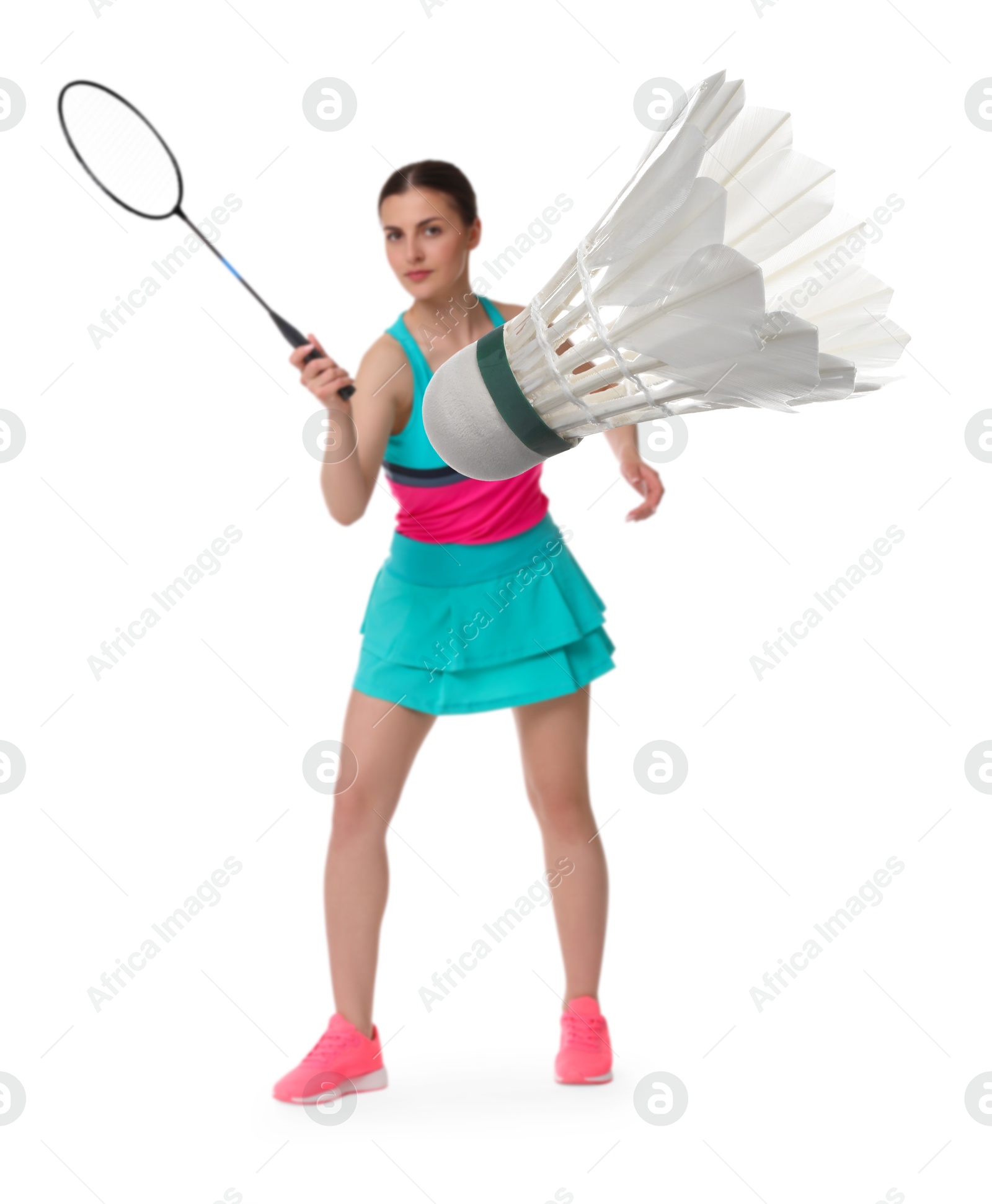 Image of Young woman playing badminton with racket and feather shuttlecock on white background