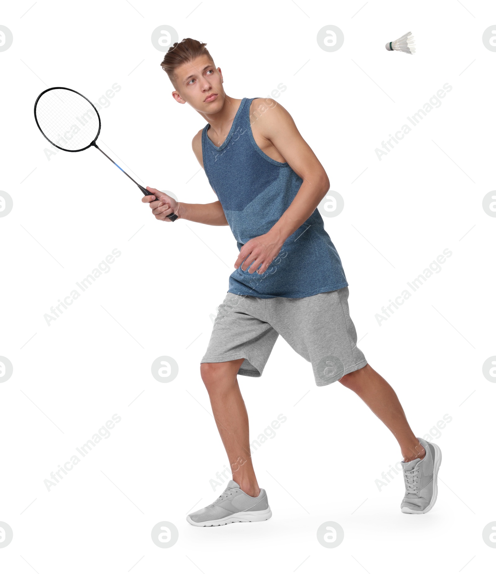 Image of Young man playing badminton with racket and feather shuttlecock on white background