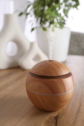 Essential oil diffuser on table in room