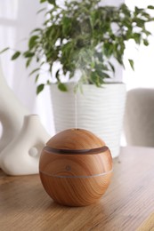 Essential oil diffuser on table in room