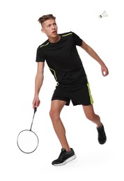 Young man playing badminton with racket and feather shuttlecock on white background