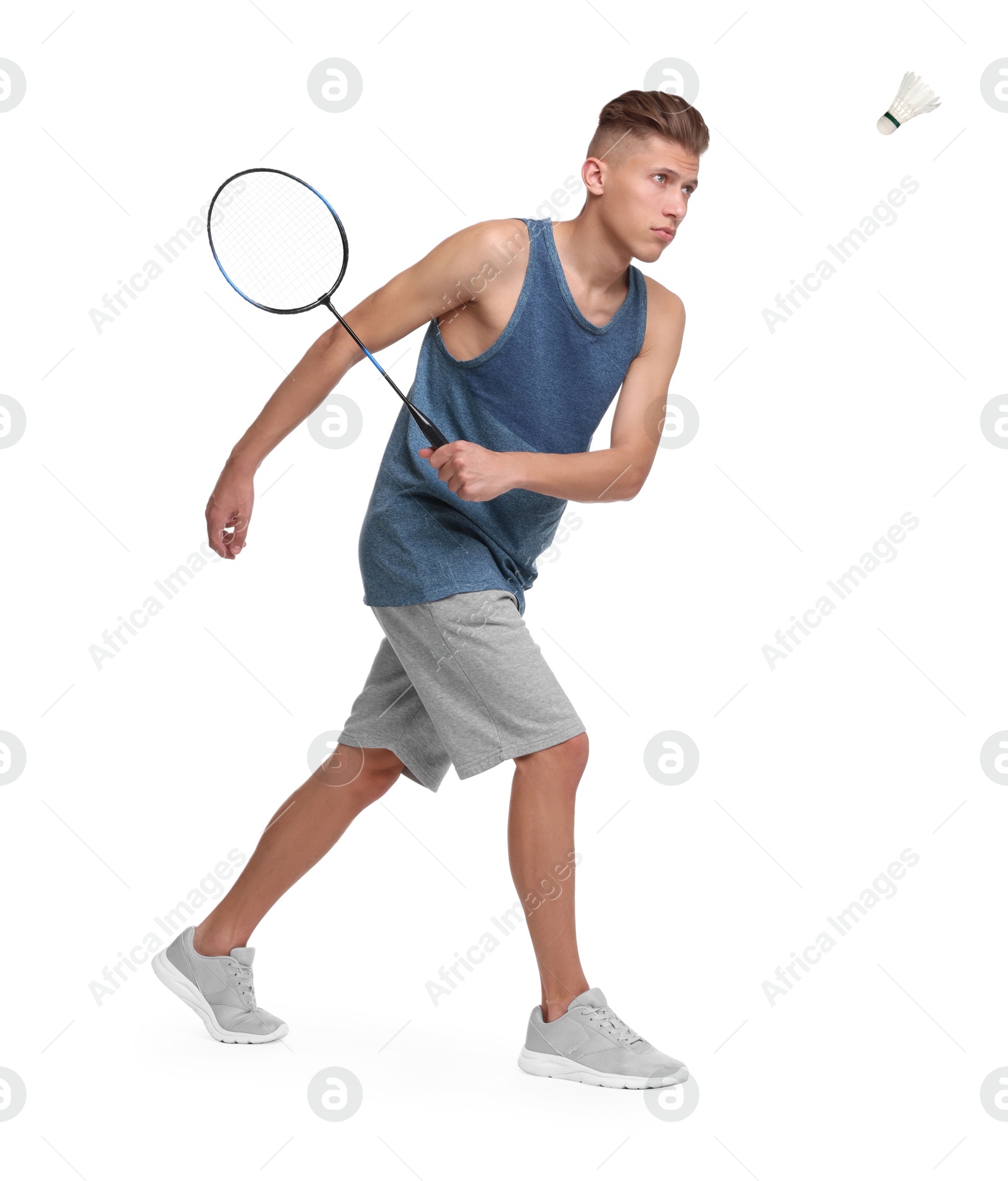 Image of Young man playing badminton with racket and feather shuttlecock on white background