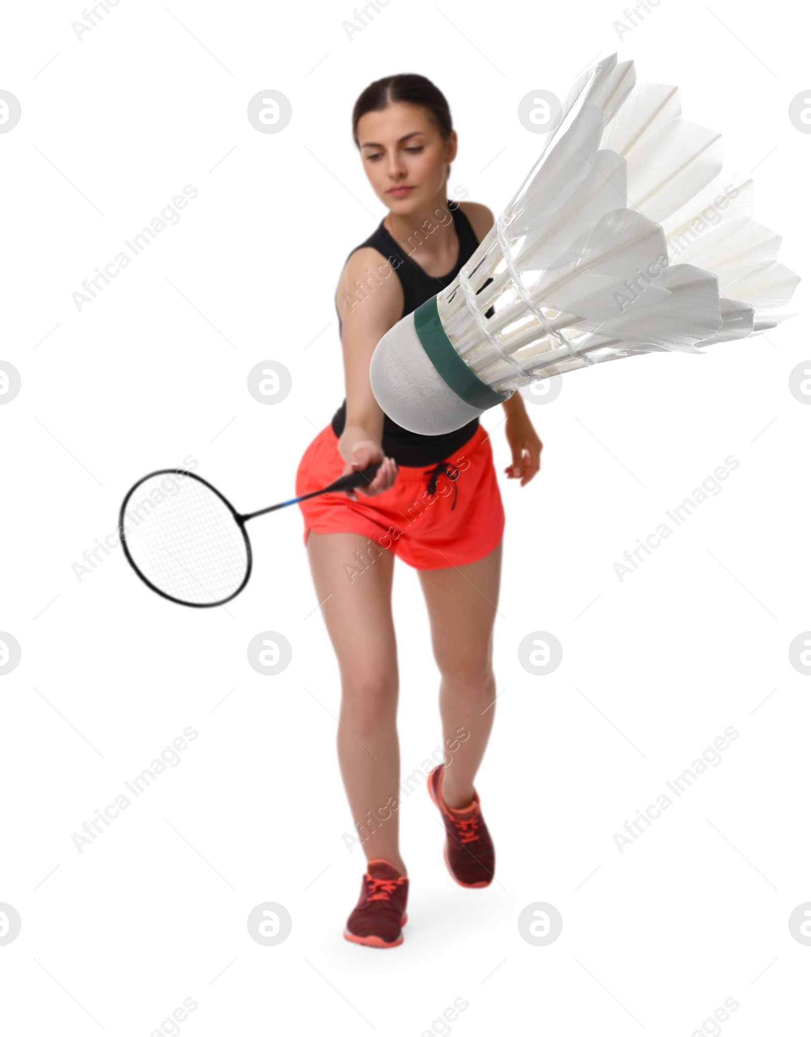 Image of Young woman playing badminton with racket and feather shuttlecock on white background