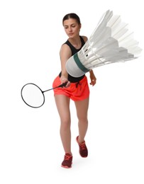 Young woman playing badminton with racket and feather shuttlecock on white background