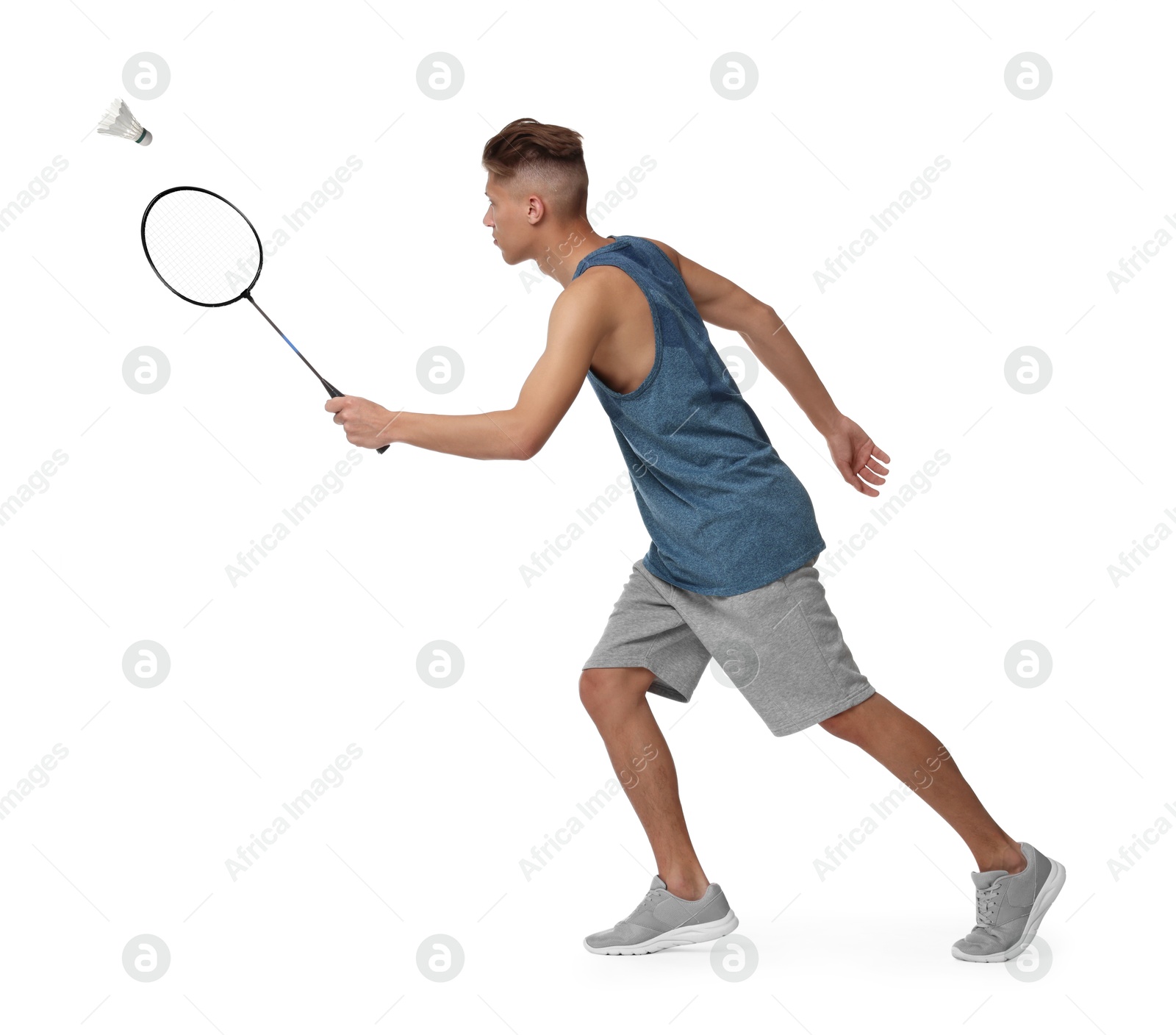 Image of Young man playing badminton with racket and feather shuttlecock on white background