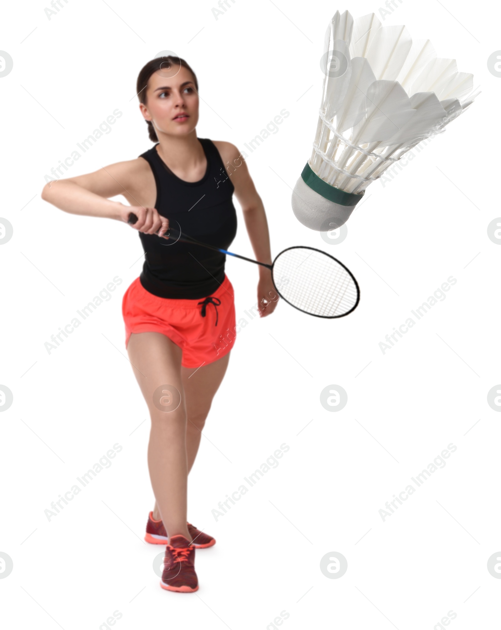 Image of Young woman playing badminton with racket and feather shuttlecock on white background