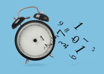 Image of Numbers flying away from alarm clock on light blue background. Time related concepts