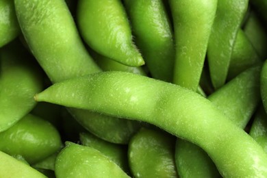 Photo of Fresh edamame pods as background, closeup view