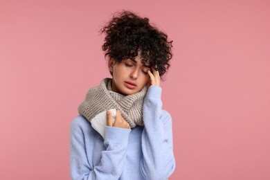 Photo of Cold symptom. Young woman with tissue on pink background