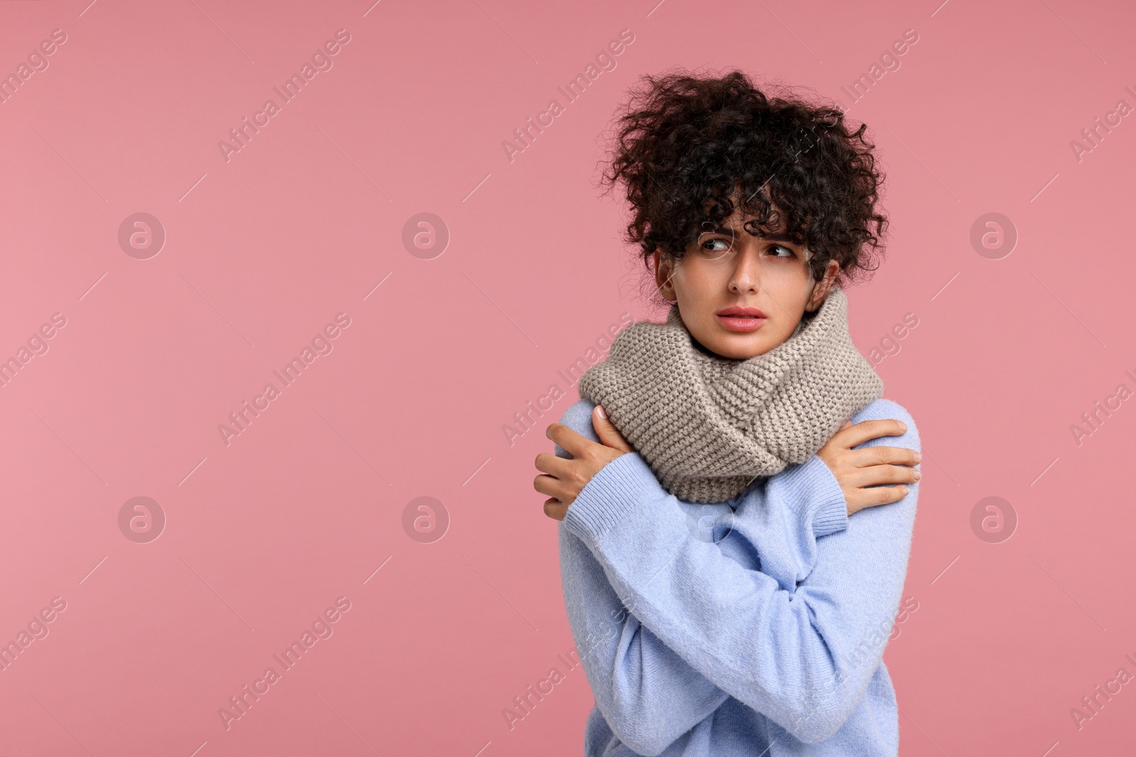 Photo of Cold symptom. Young woman suffering from illness on pink background, space for text