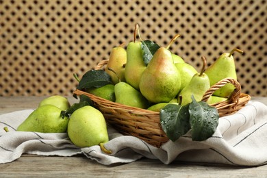 Photo of Fresh green pears and leaves with water drops on wooden table