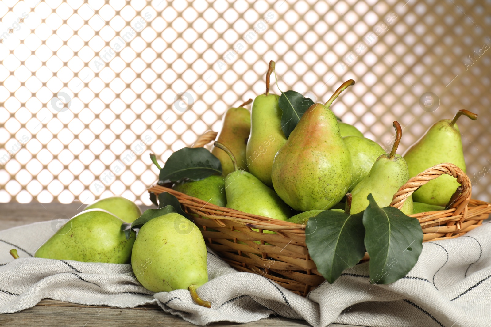 Photo of Fresh green pears and leaves on wooden table, closeup