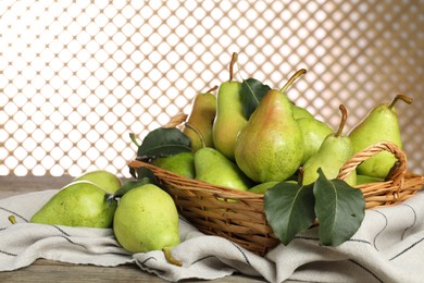 Photo of Fresh green pears and leaves on wooden table, closeup