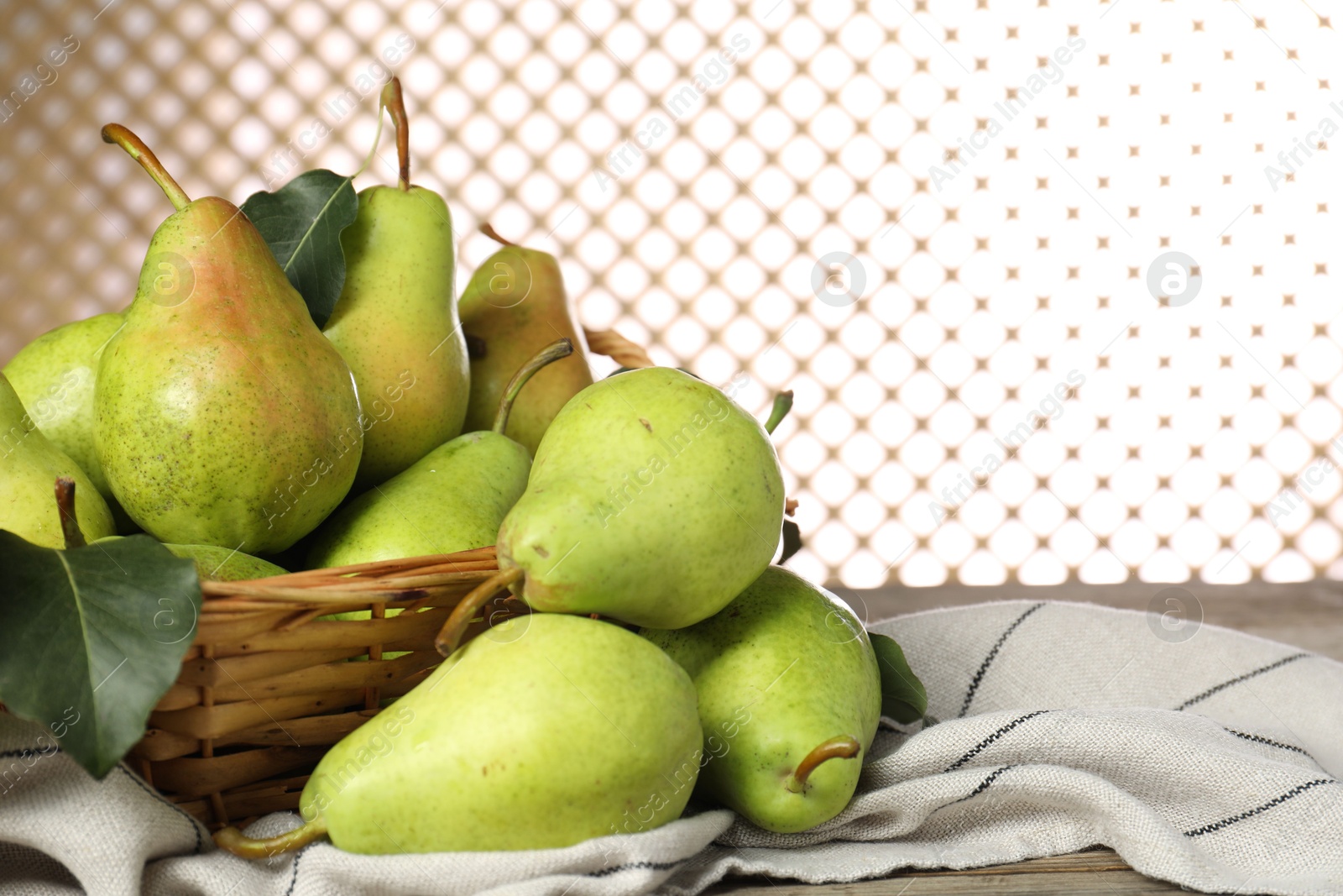 Photo of Fresh green pears and leaves on wooden table, closeup. Space for text