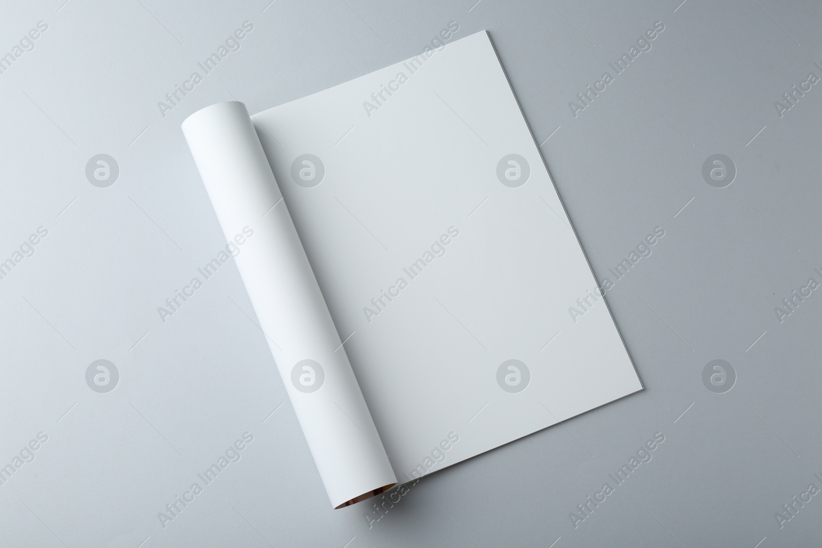 Photo of Open magazine with blank page on grey background, top view. Mockup for design