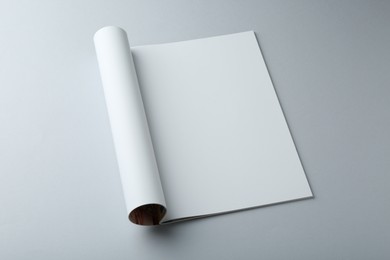 Photo of Open magazine with blank page on grey background. Mockup for design