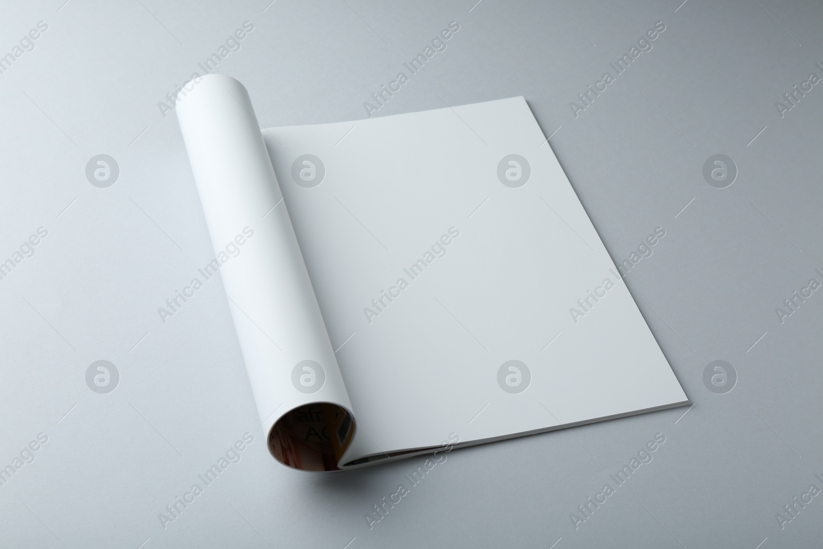 Photo of Open magazine with blank page on grey background. Mockup for design