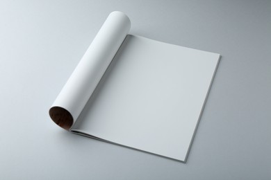 Photo of Open magazine with blank page on grey background. Mockup for design