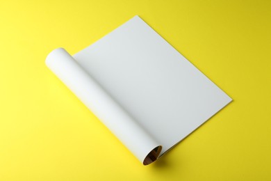 Open magazine with blank page on yellow background. Mockup for design