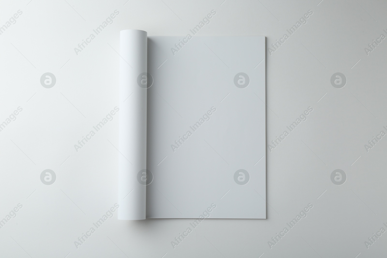 Photo of Open magazine with blank page on white background, top view. Mockup for design