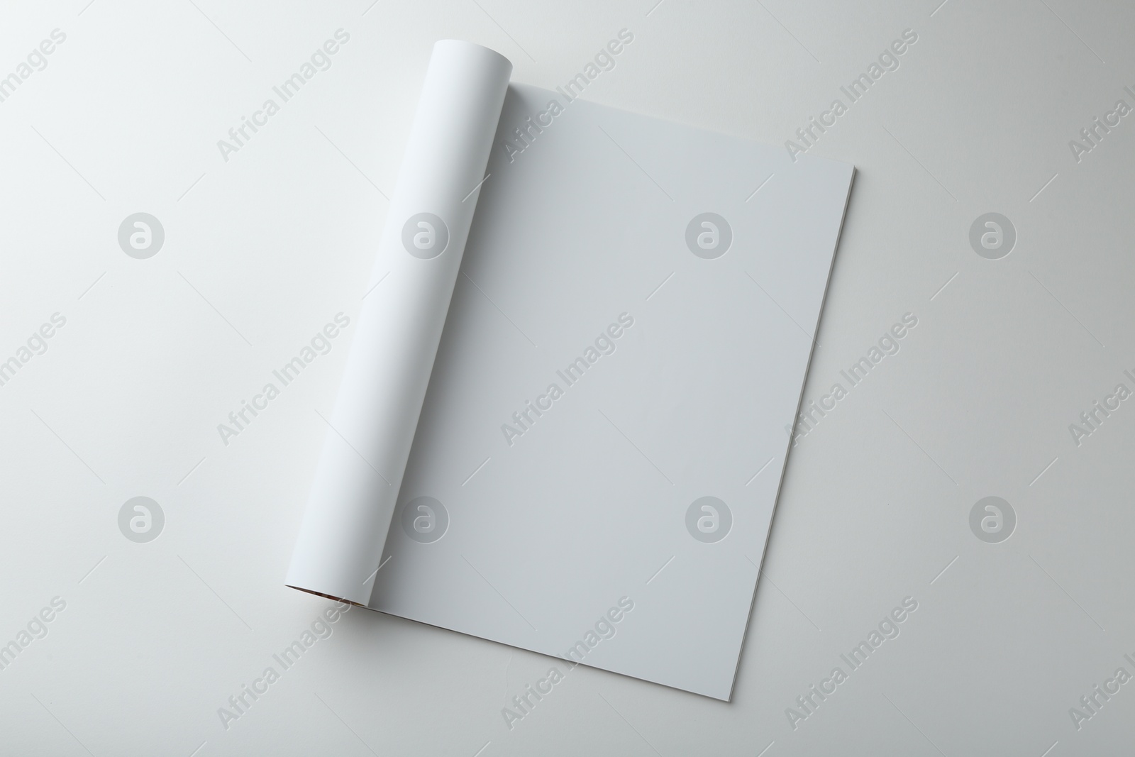 Photo of Open magazine with blank page on white background, top view. Mockup for design