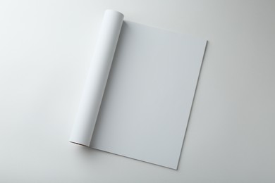 Photo of Open magazine with blank page on white background, top view. Mockup for design