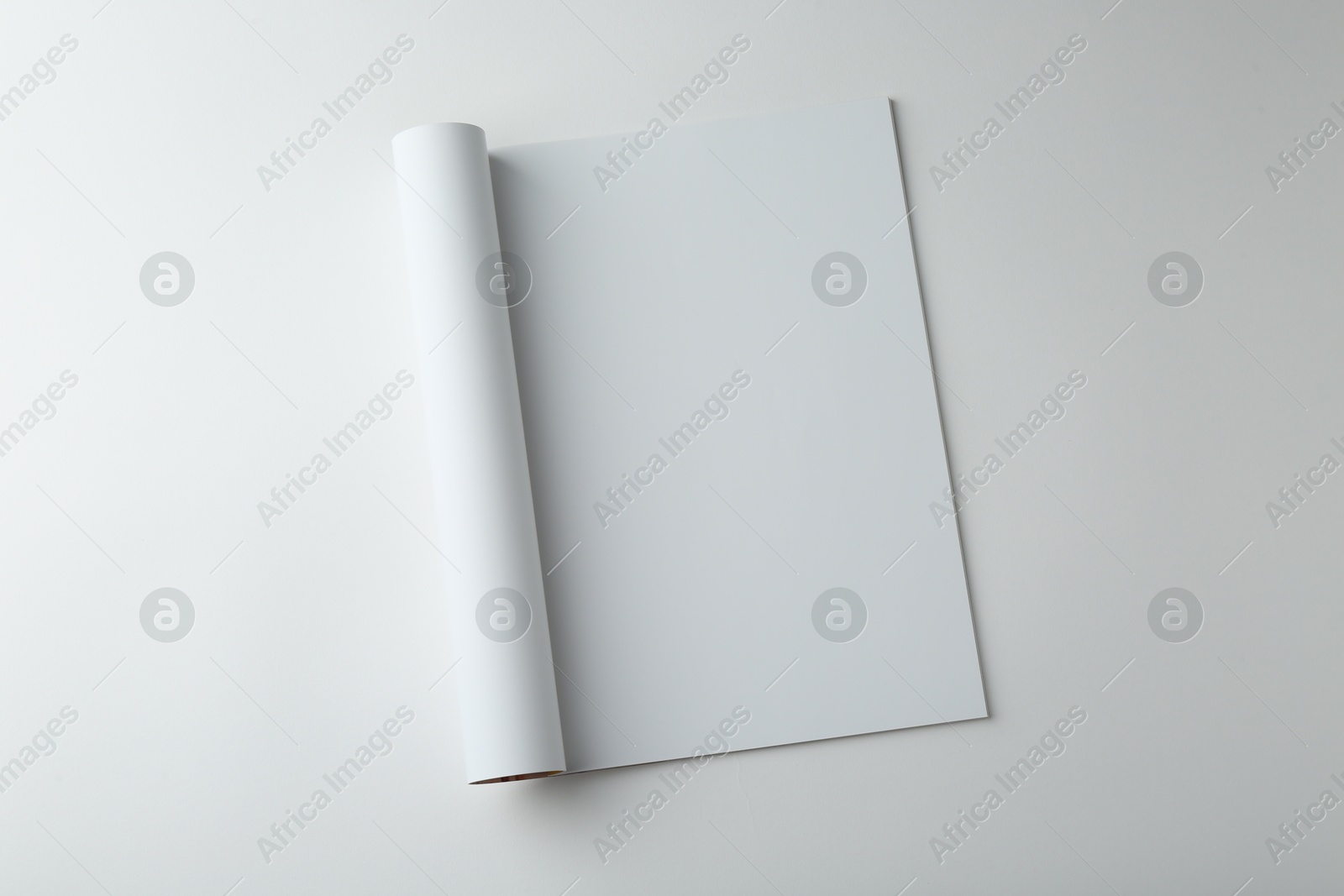 Photo of Open magazine with blank page on white background, top view. Mockup for design