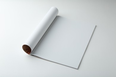 Open magazine with blank page on white background. Mockup for design