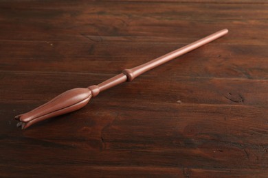 Photo of One old magic wand on wooden table, closeup