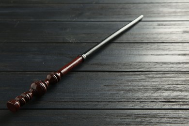 One old magic wand on wooden table, closeup